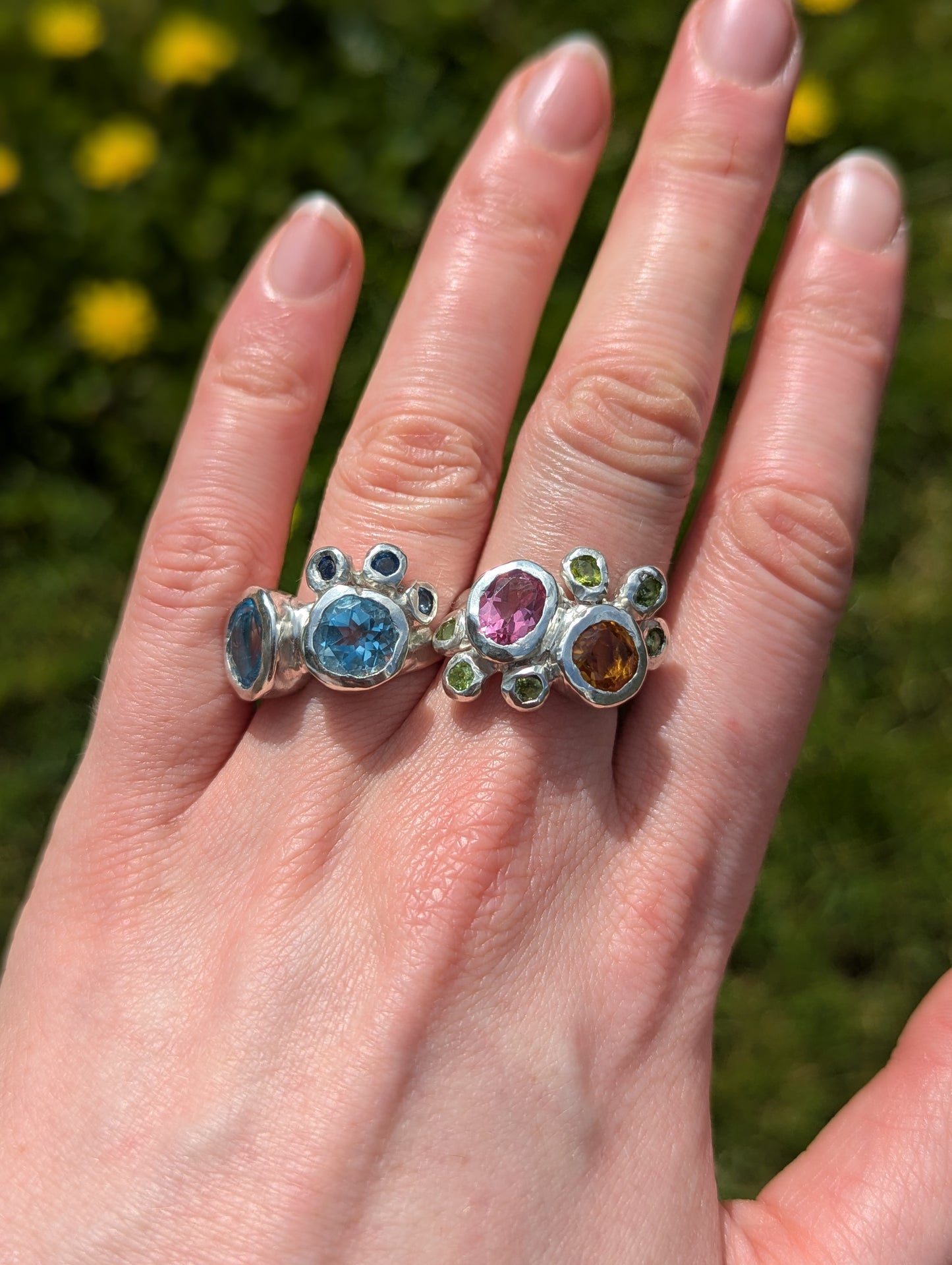 Artistic_handmade_rings_with_blue_gemstones_pink_gemstones_orange_gemstones_and_green_gemstones