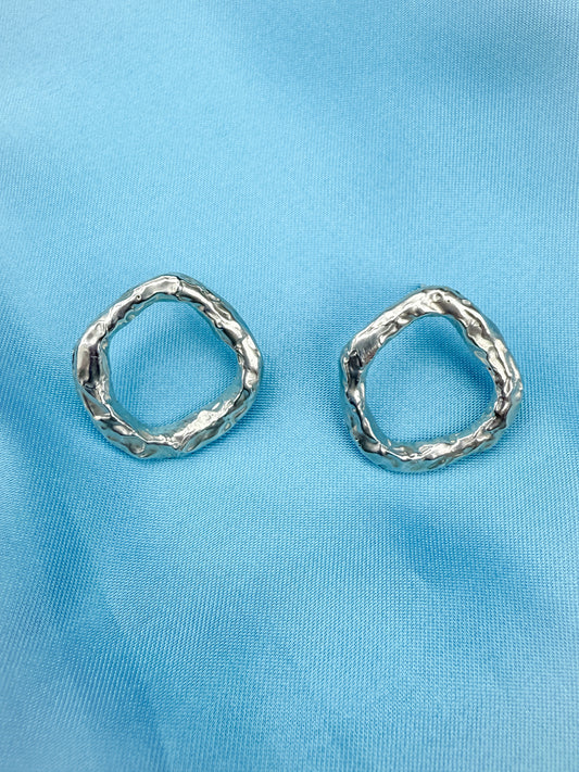 Silver Circle Stud Earrings on Blue Background