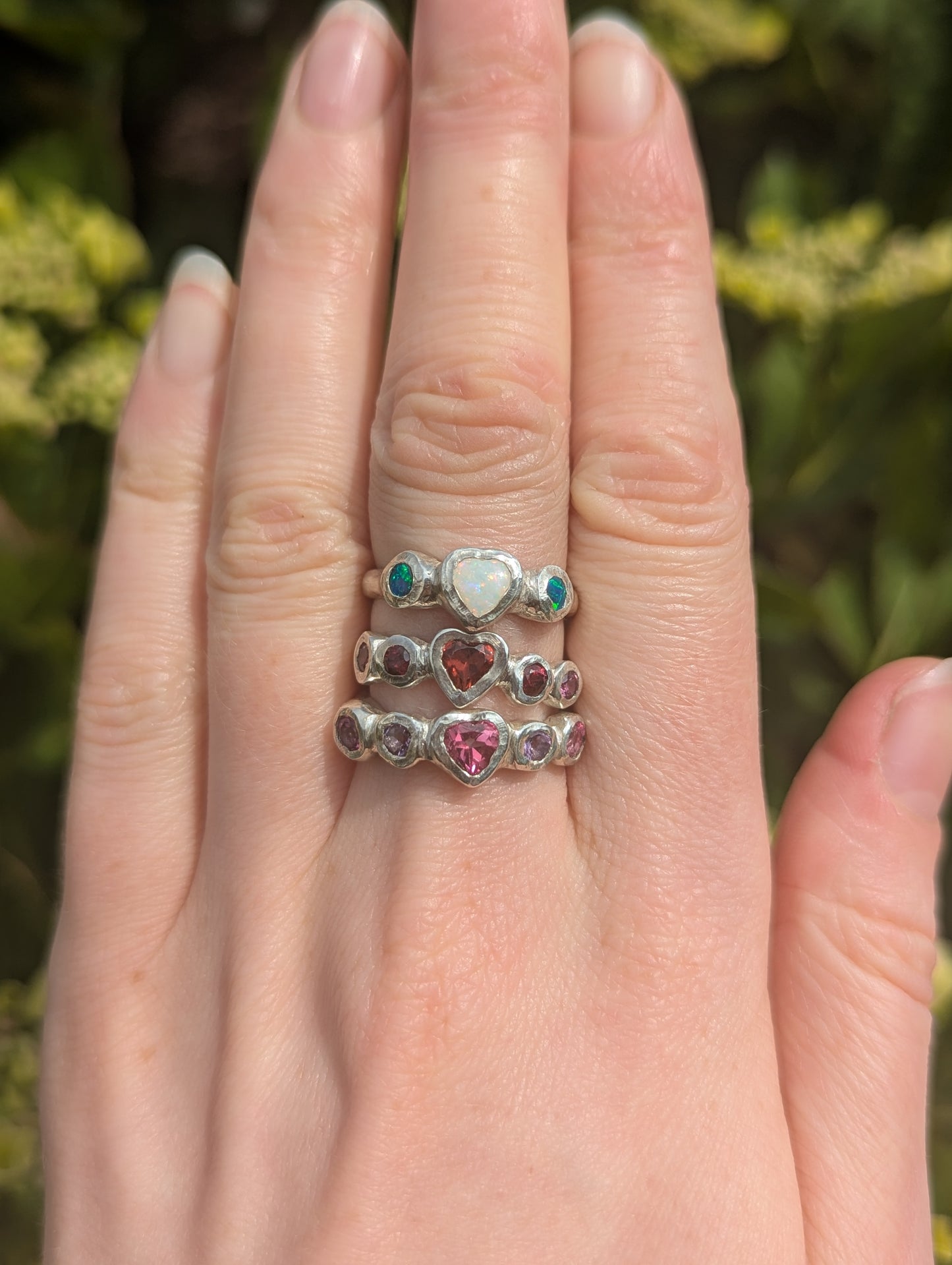 Three silver heart gemstone rings