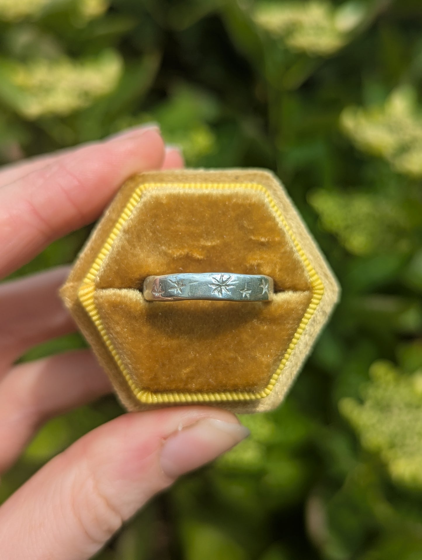 Silver ring with etched stars in yellow box