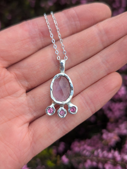 Amethyst_and_pink_topaz_recycled_sterling_silver_fun_feminine_handmade_pendant_against_flower_background
