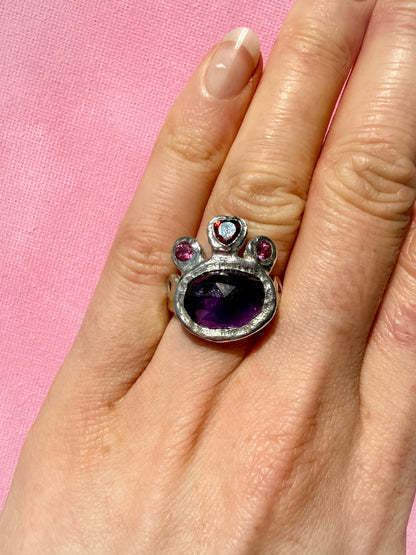 Dark amethyst slice, garnet heart, pink topaz and ruby handmade silver ring on hand