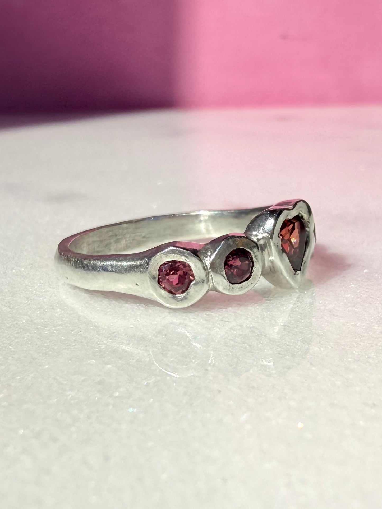 Garnet heart, rhodolite garnet, and pink tourmaline handmade silver ring side view 1