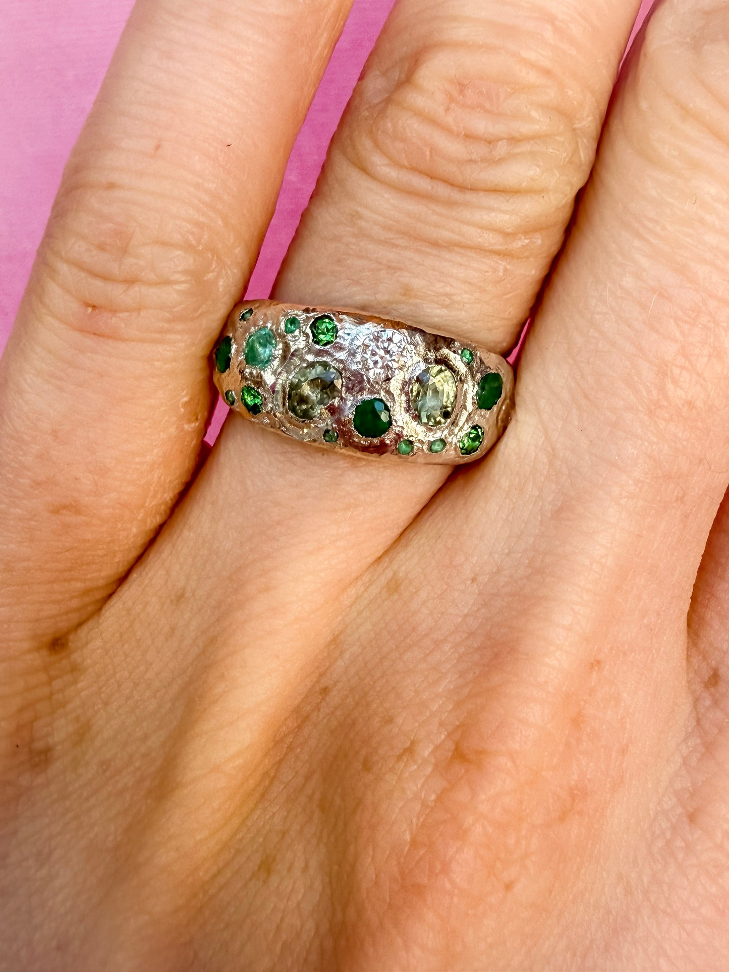 Green sapphire, emerald, tsavorite garnet and moissanite handmade silver ring on hand