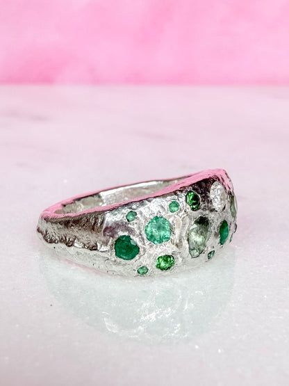 Green sapphire, emerald, tsavorite garnet and moissanite handmade silver ring on white background side view