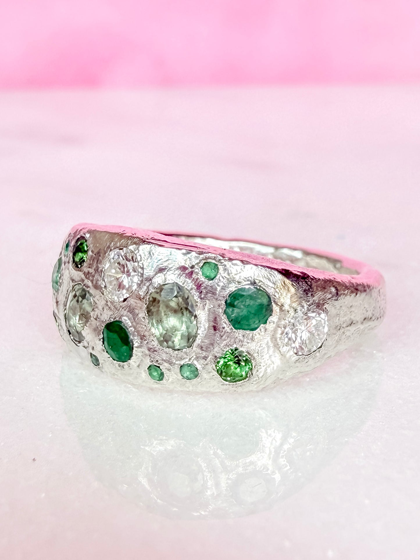 Green sapphire, emerald, tsavorite garnet and moissanite handmade silver ring side view white background