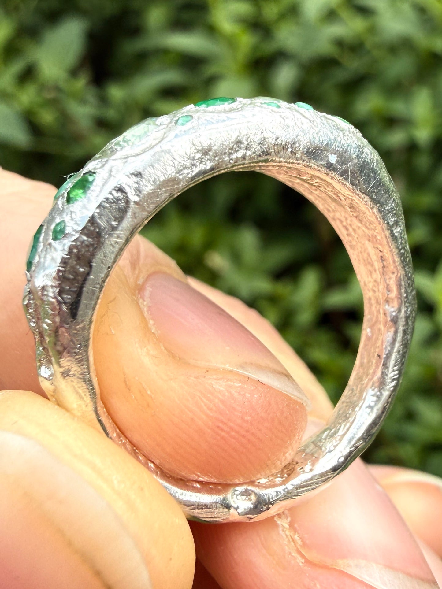 Green sapphire, emerald, tsavorite garnet and moissanite handmade silver ring close up of sand cast texture