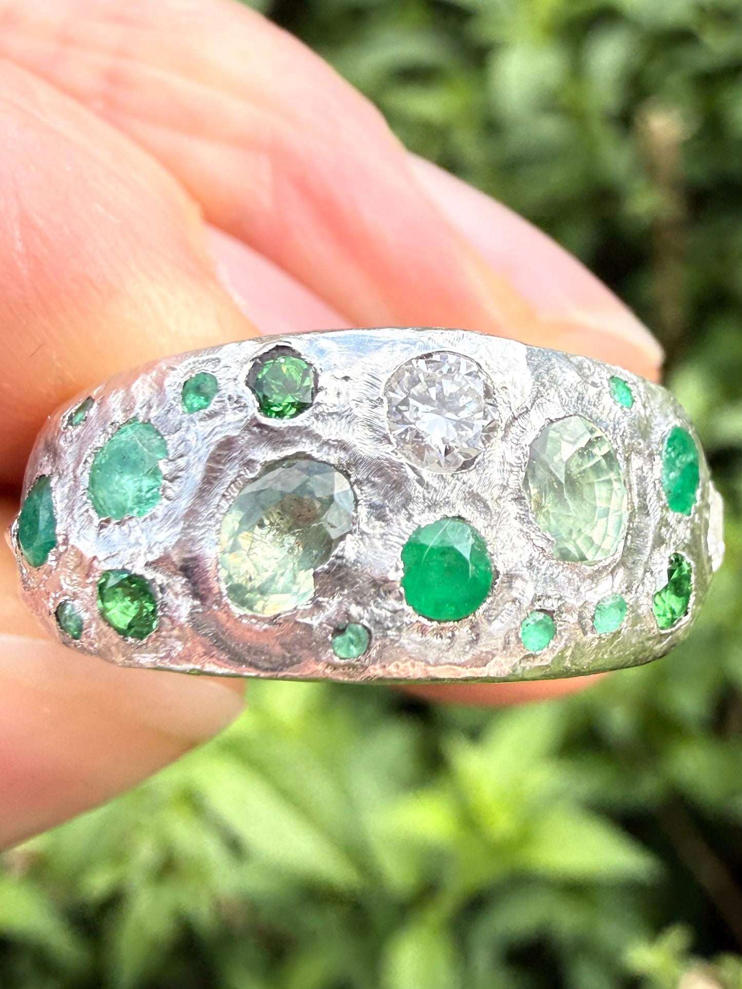 Green sapphire, emerald, tsavorite garnet and moissanite handmade silver ring close up of sand cast texture 2