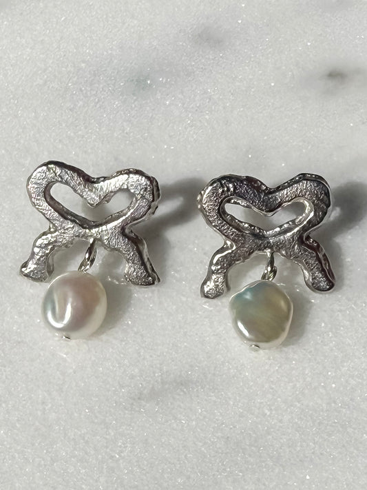 Keshi Pearl and Silver Bow Handmade Silver Earrings on marble surface