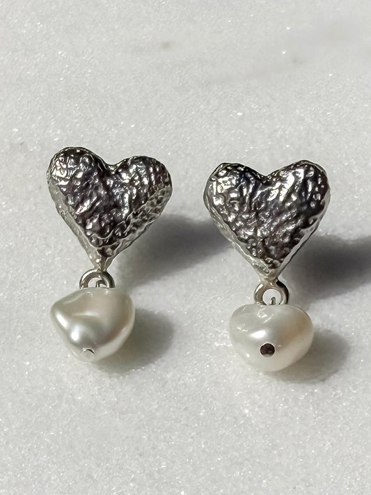 Keshi pearl and silver bow handmade silver earrings on marble surface