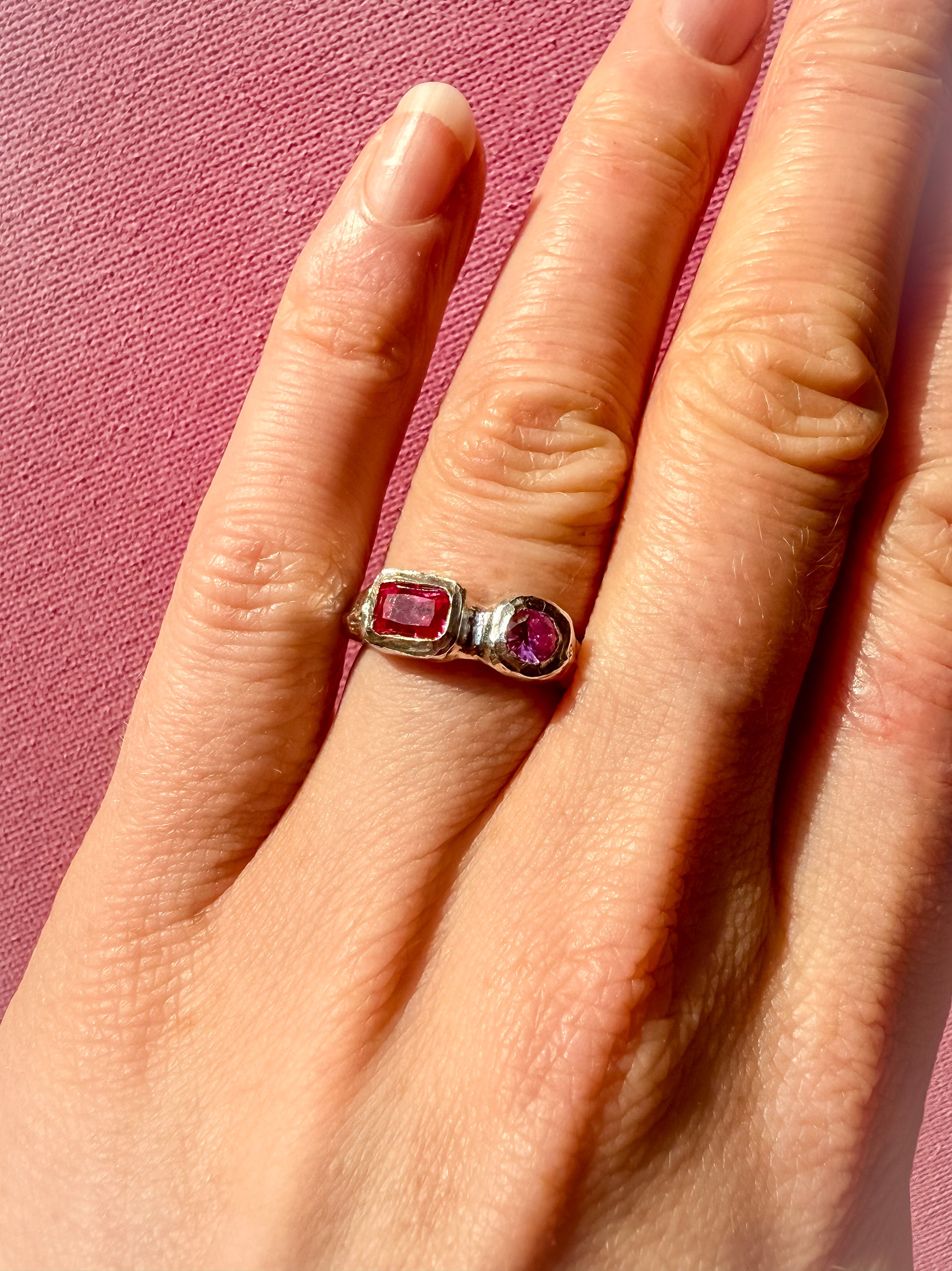 Lab grown octagon ruby and lab grown round pink sapphire handmade silver ring on hand