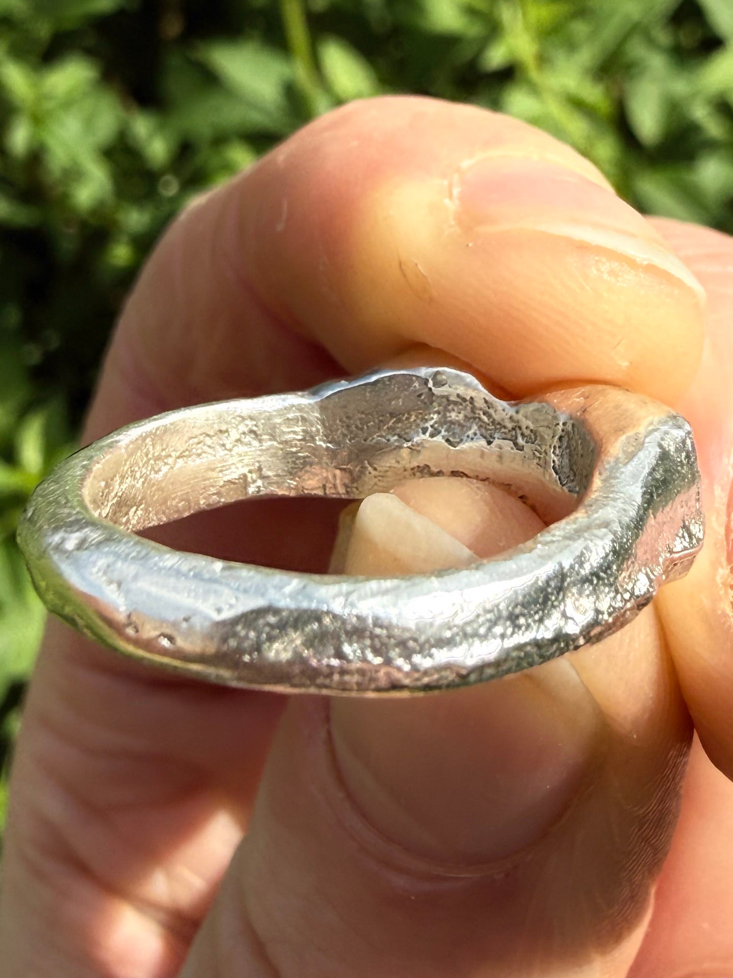 Lab grown octagon ruby and lab grown round pink sapphire handmade silver ring close up of sand cast texture 3
