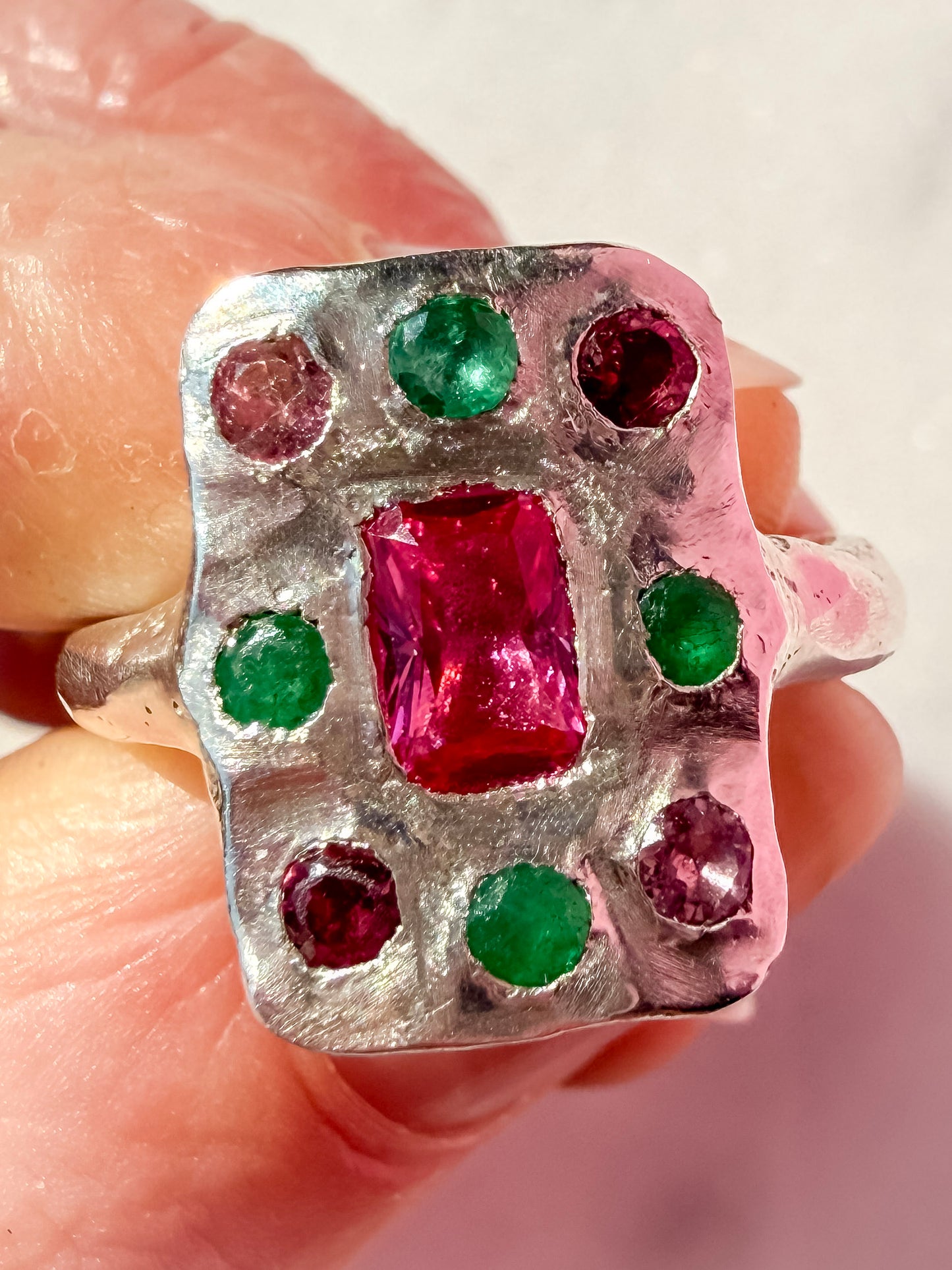 Lab ruby, emerald and pink tourmaline handmade silver oblong ring up close of ring surface