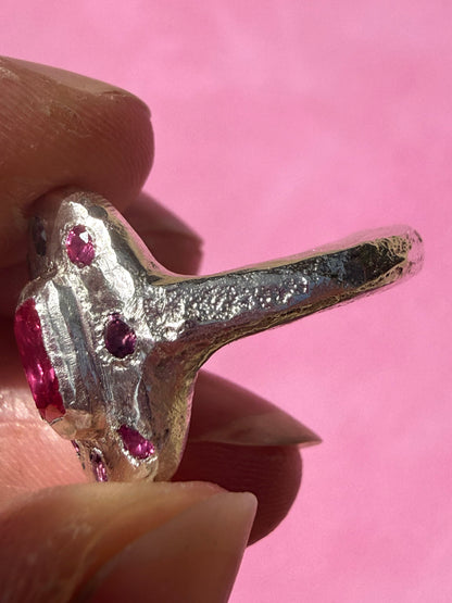 Lab ruby, rhodolite and ruby handmade silver oval ring up close sand cast texture on ring shank 3