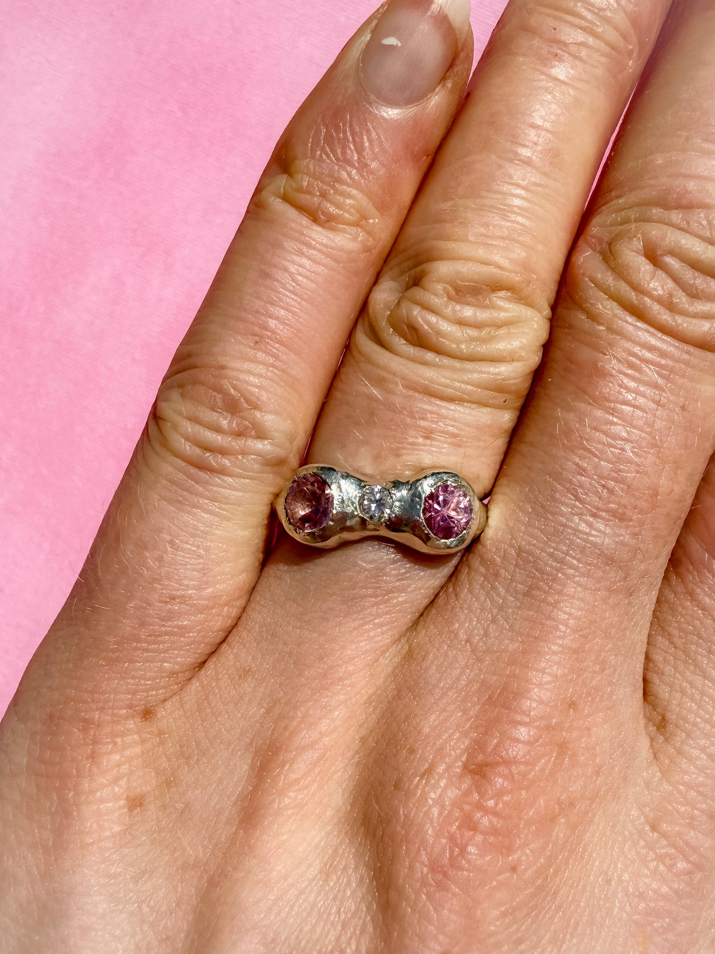 Natural pink tourmaline and lab-grown moissanite handmade silver ring on hand