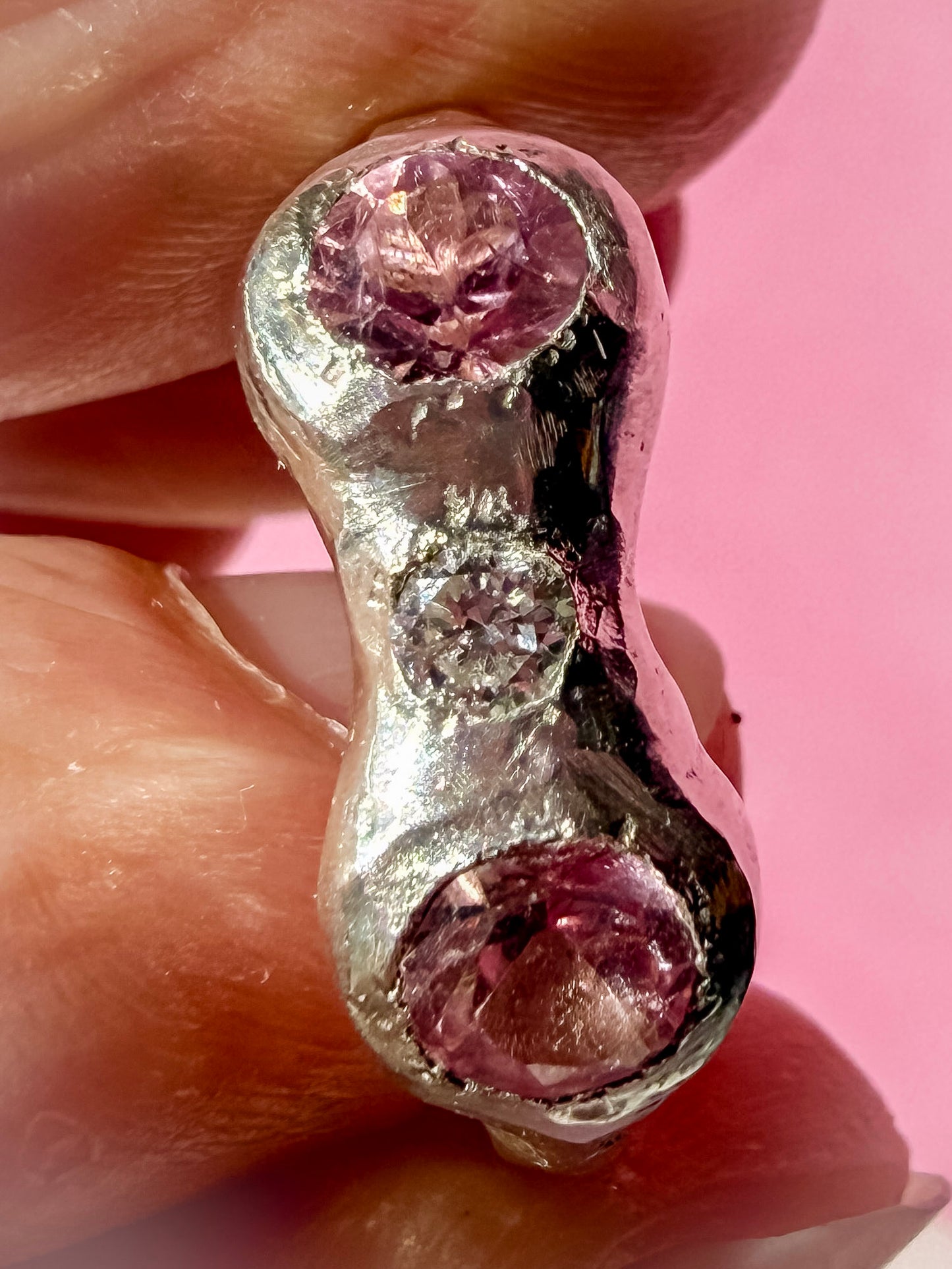 Natural pink tourmaline and lab-grown moissanite handmade silver ring up close face