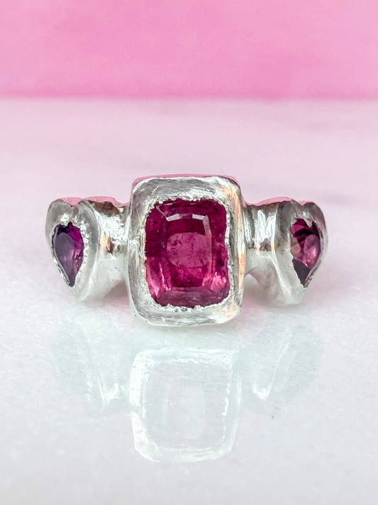 Octagon cushion cut hot pink tourmaline and purple rhodolite heart handmade silver ring on pink and white background