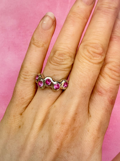 Pink Lab-Grown Sapphire Silver Handmade Ring on hand against pink background