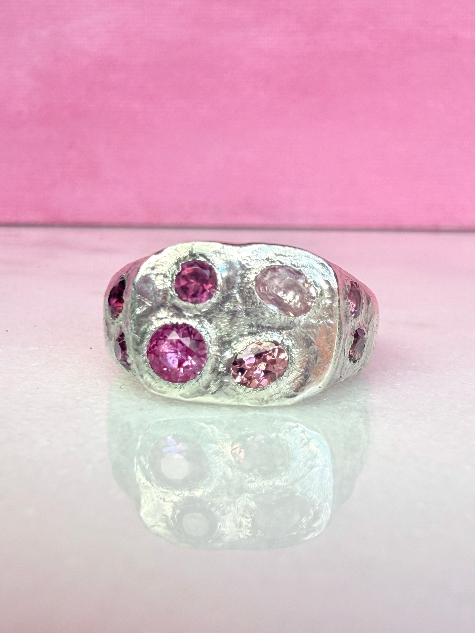 Pink tourmaline and pink sapphire handmade silver signet ring on white background