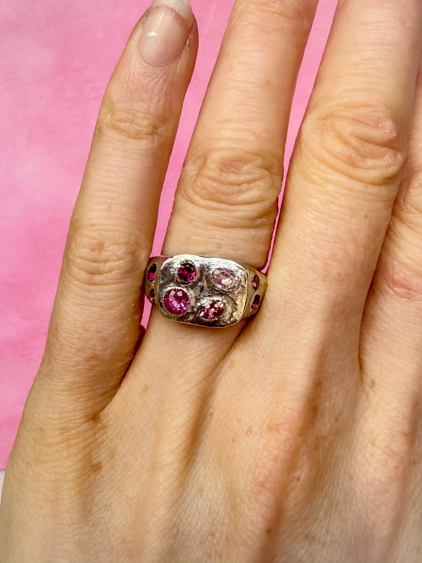 Pink tourmaline and pink sapphire handmade silver signet ring on hand