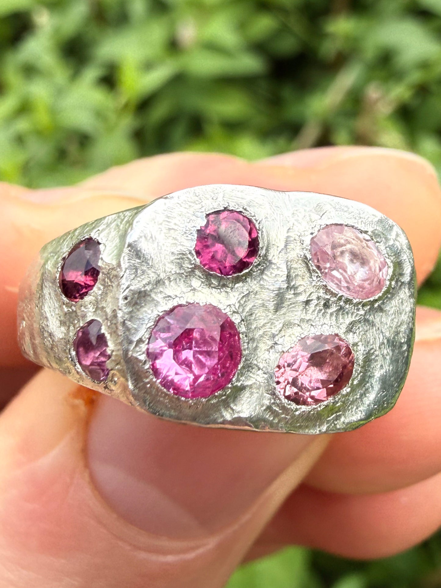 Pink tourmaline and pink sapphire handmade silver signet ring sand cast texture up close face