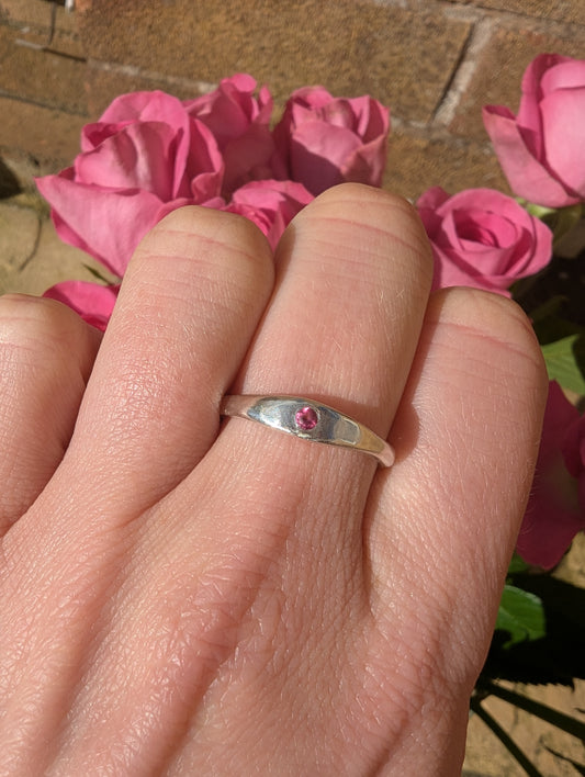 Skinny Minnie Pink Topaz Stacking Ring in Sterling Silver Against Pink Roses