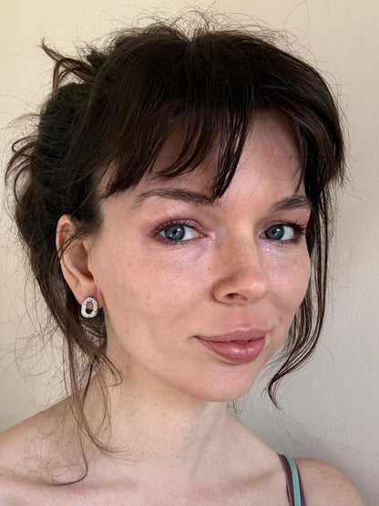 Small Textured Silver Oval Handmade Earrings in ear