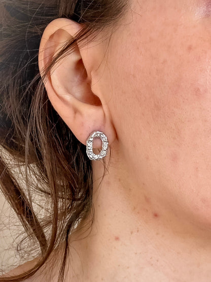 Small Textured Silver Oval Handmade Earrings close up in ear