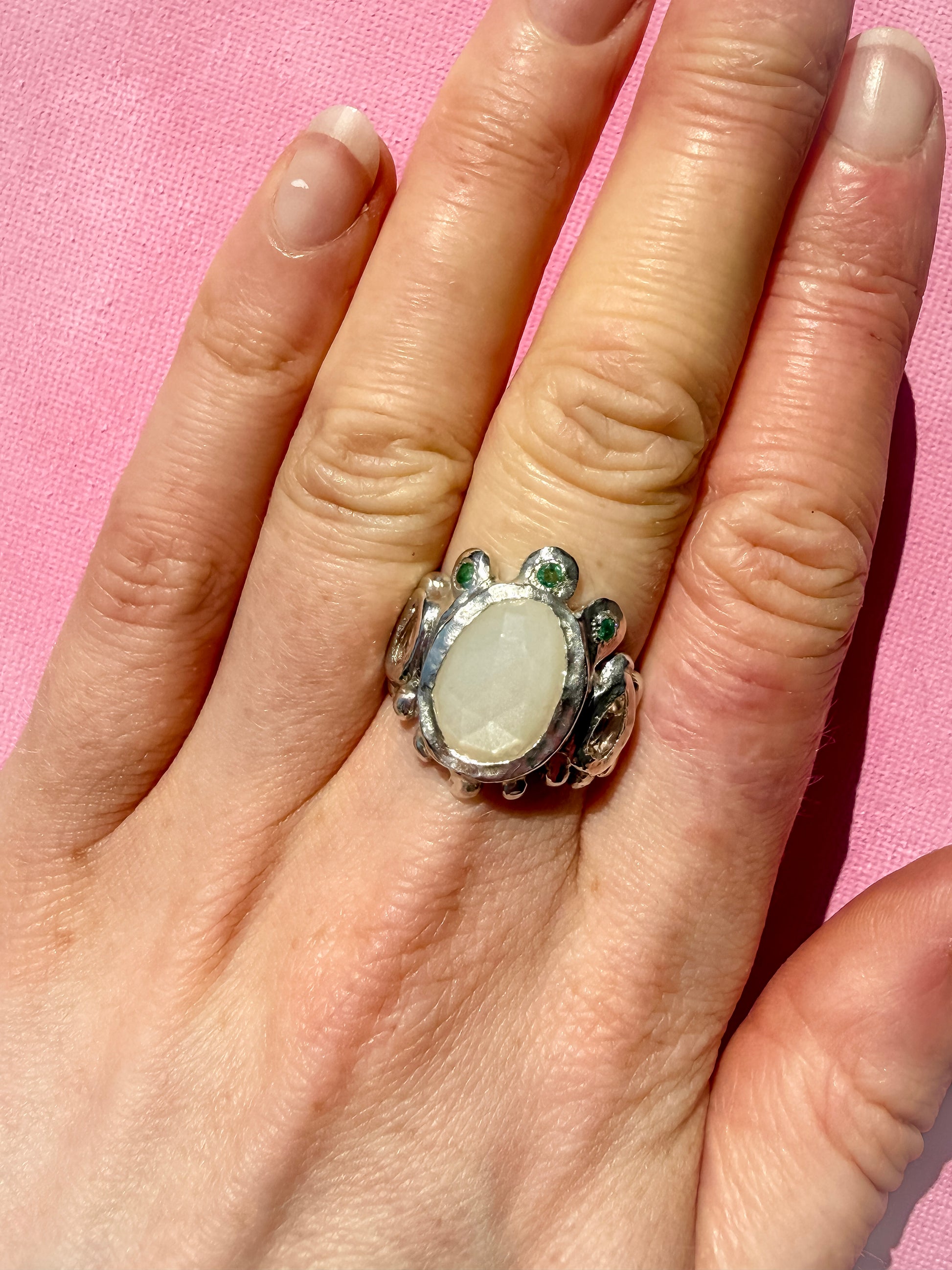 White moonstone slice, peach morganite faceted pear and emerald handmade silver ring on hand