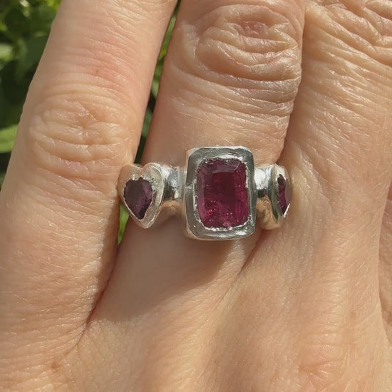 Octagon_cushion_cut_hot_pink_tourmaline_and_purple_rhodolite_heart_handmade_silver_ring_sparkling_in_sunlight