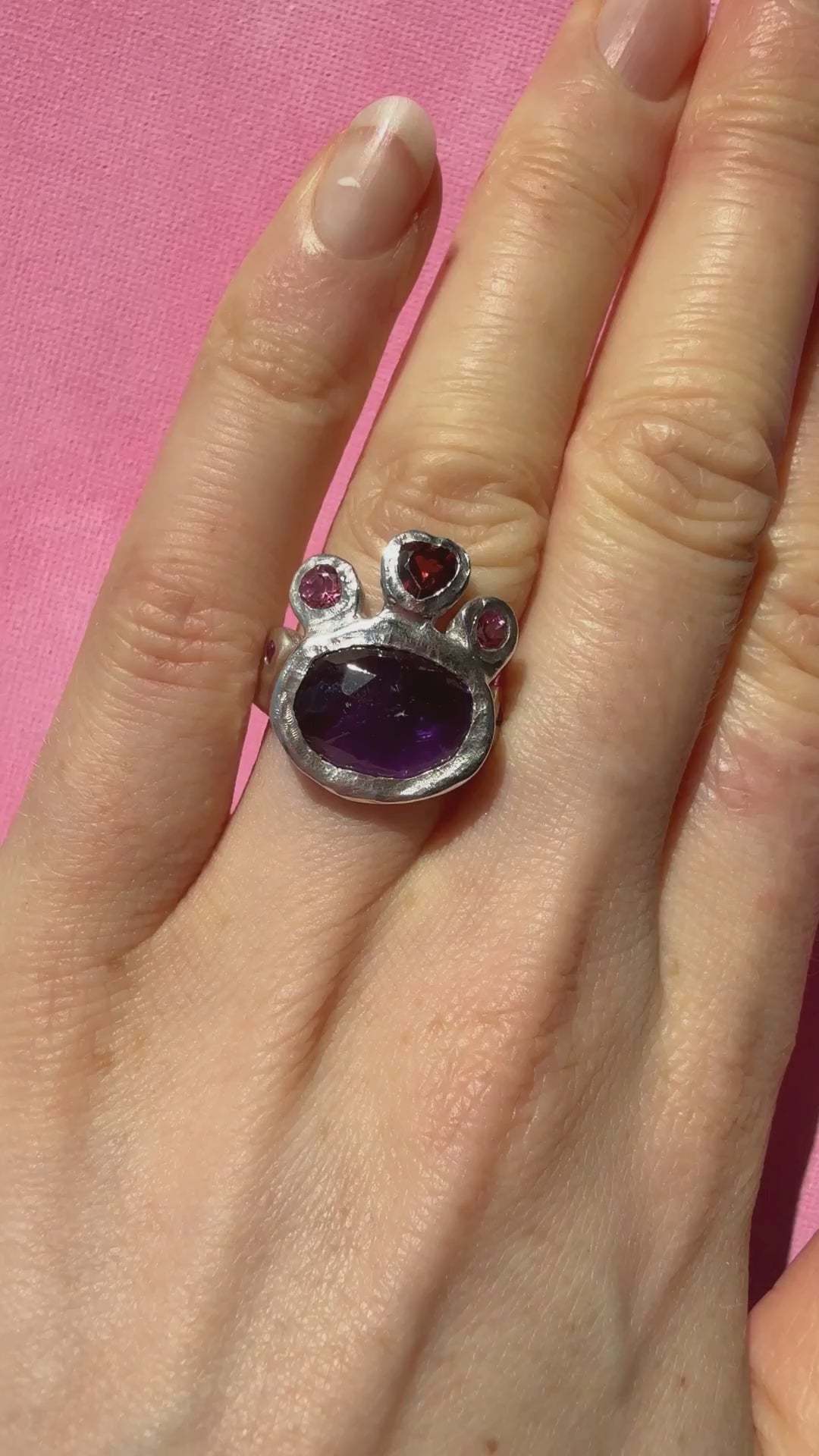 Dark amethyst slice, garnet heart, pink topaz and ruby handmade silver ring video of ring on hand in the sun