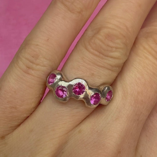Pink Lab-Grown Sapphire Silver Handmade Ring on hand sparkling in sunlight