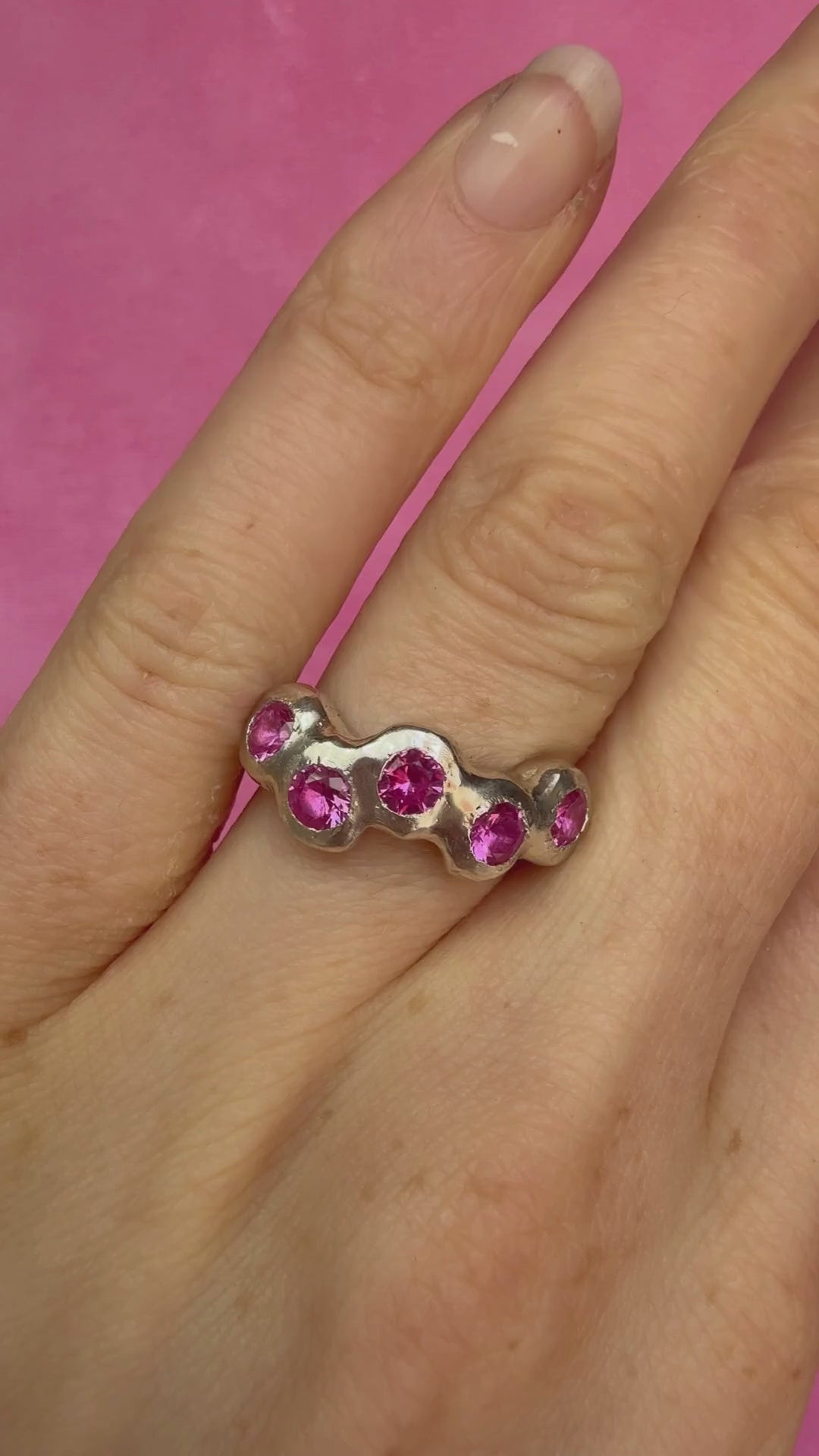 Pink Lab-Grown Sapphire Silver Handmade Ring on hand sparkling in sunlight