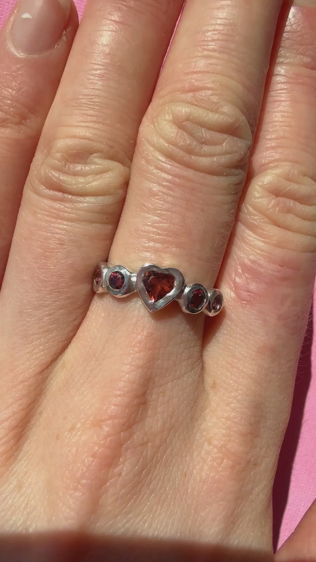 Garnet heart, rhodolite garnet, and pink tourmaline handmade silver ring video of ring on hand sparkling in the sun