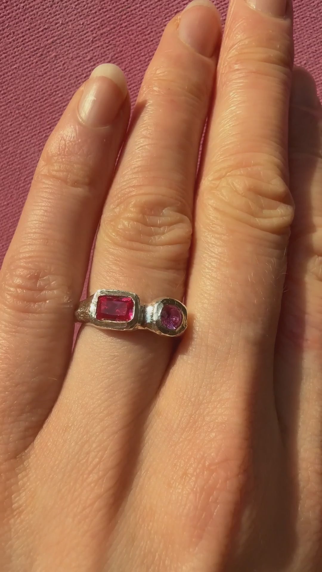 Lab grown octagon ruby and lab grown round pink sapphire handmade silver ring sparkling in the sun on hand